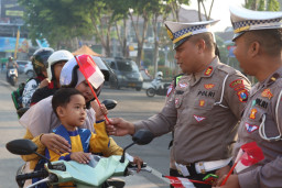 Sentuh Hati Pengguna Jalan, Satlantas Sampang Bagikan Merah Putih Sambut Kemerdekaan